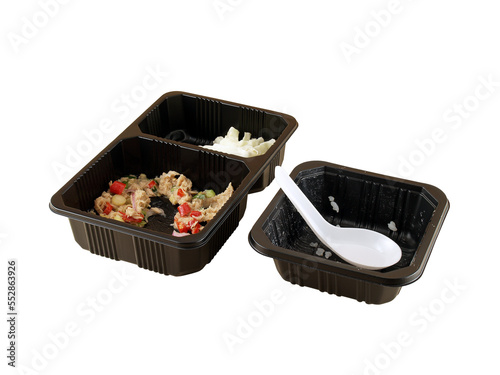 few grain of steamed rice with white plastic spoon in black plastic deep tray and spicy tuna salad in two hole plastic tray isolated on white background, food waste in disposable microwave containers