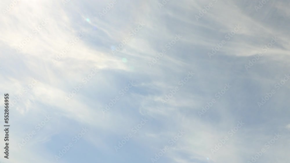 Cirrus clouds moving across the frame in blue sky and sun flare timelapse 4K Cirrus clouds moving across the frame in blue sky and sun flare timelapse 4K
