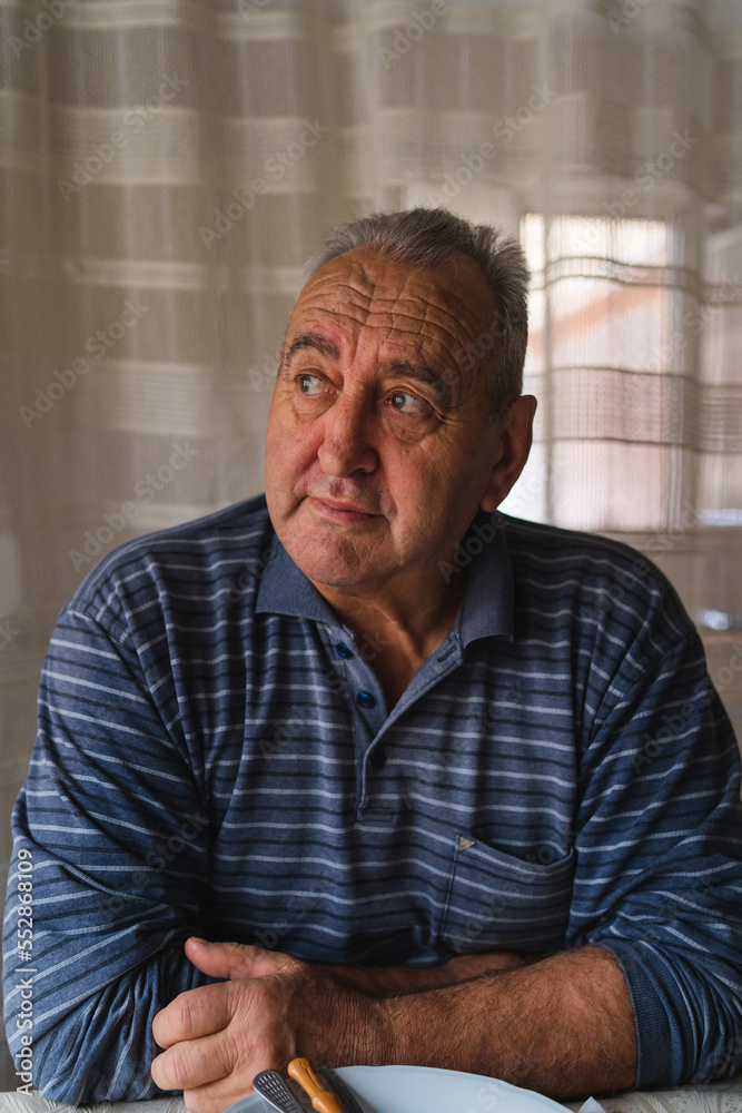 A portrait of grandfather at his house at the village drinking rakija alcoholic drink A portrait of grandfather at his house at the village drinking rakija alcoholic drink