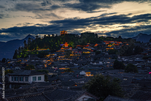 Rooftops in Lijiang old town and jade dragon snow mountains in the background, beautiful view from Lijiang