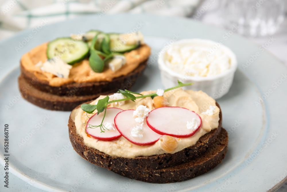 Delicious sandwiches with hummus and different ingredients on plate Delicious sandwiches with hummus and different ingredients on plate
