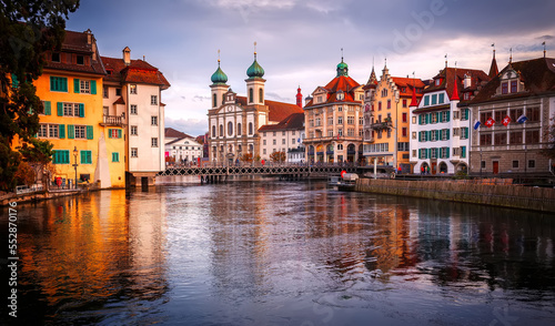 Panorama view on Old Town medieval architecture in Lucerne, Vivid nature scenery of lake Lucerne during sunset. Switzerland. Beautiful historic city center, popular travel destination.
