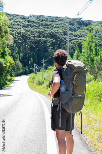 young man with a travel backpack in a beautiful landscape