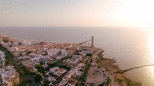 Sky view of the beautiful city Chipiona flying a drone, in the province of Cadiz (Andalucia, Spain). In the shot is shown Chipiona's lighthouse at the coast, and typical andalusian small white houses.