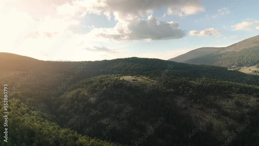 Beautiful aerial drone scene of a refuge or cabin (house) in the middle of mountains at sunset in Sierra de Gredos, Guadarrama a mountain range of the Sistema Central between Madrid and Segovia Spain