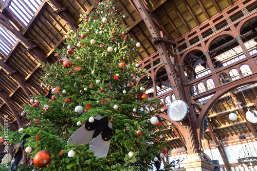 Photography Beautiful tall christmas tree decorated with colorful balls.