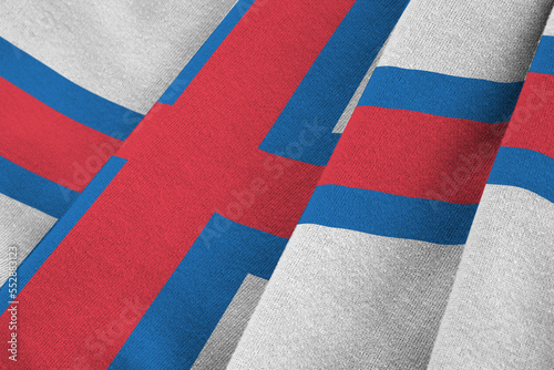 Faroe islands flag with big folds waving close up under the studio light indoors. The official symbols and colors in fabric banner photo