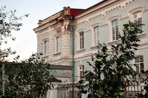 Old city buildings with ancient windows, roofs, balconies. sculptures, walls 
