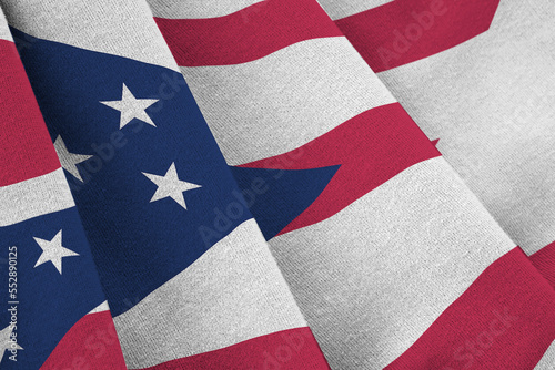 Ohio US state flag with big folds waving close up under the studio light indoors. The official symbols and colors in fabric banner photo