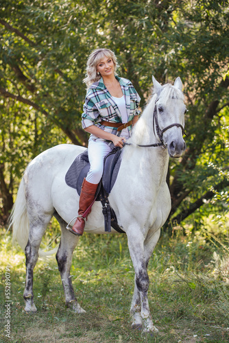 beautiful woman riding a white horse