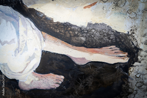 The girl lies in an earthen pit. A clothed woman with red hair. Oil painting portrait with biblical melancholic subject. Fragment of a painting with hands.