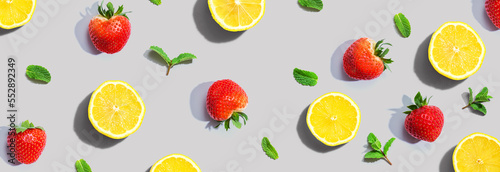 Fototapeta Naklejka Na Ścianę i Meble -  Fresh lemons and strawberries with mints overhead view - flat lay