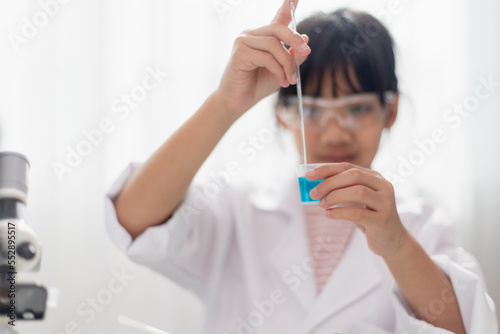 education  science  chemistry and children concept - kids or students with test tube making experiment at school laboratory