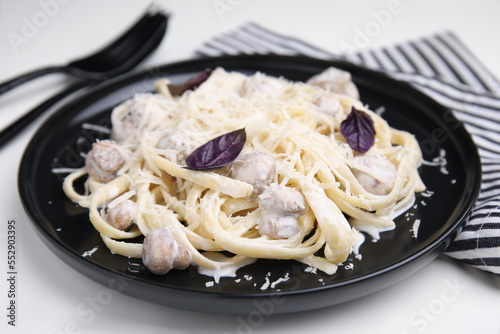 Delicious pasta with mushrooms served on white table, closeup