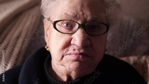 beautiful portrait of alone ederly  woman looking at the camera - old age