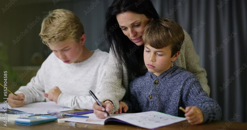 Mother helping boys with homework assignment, teaching and learning. Homeschool son and little brother learning education with a friendly and caring female tutor, smiling and tutoring smart children Mother helping boys with homework assignment, teaching and learning. Homeschool son and little brother learning education with a friendly and caring female tutor, smiling and tutoring smart children