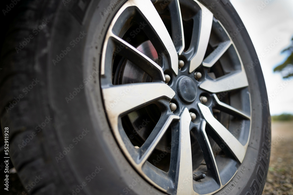 woman changing a tyre in the country. girl mechanic changing a tire woman changing a tyre in the country. girl mechanic changing a tire