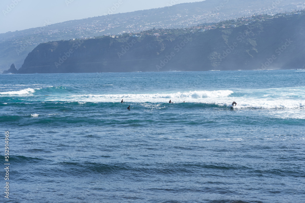 A group of surfers on the waves. Tenerife. Canary Islands. Spain A group of surfers on the waves. Tenerife. Canary Islands. Spain
