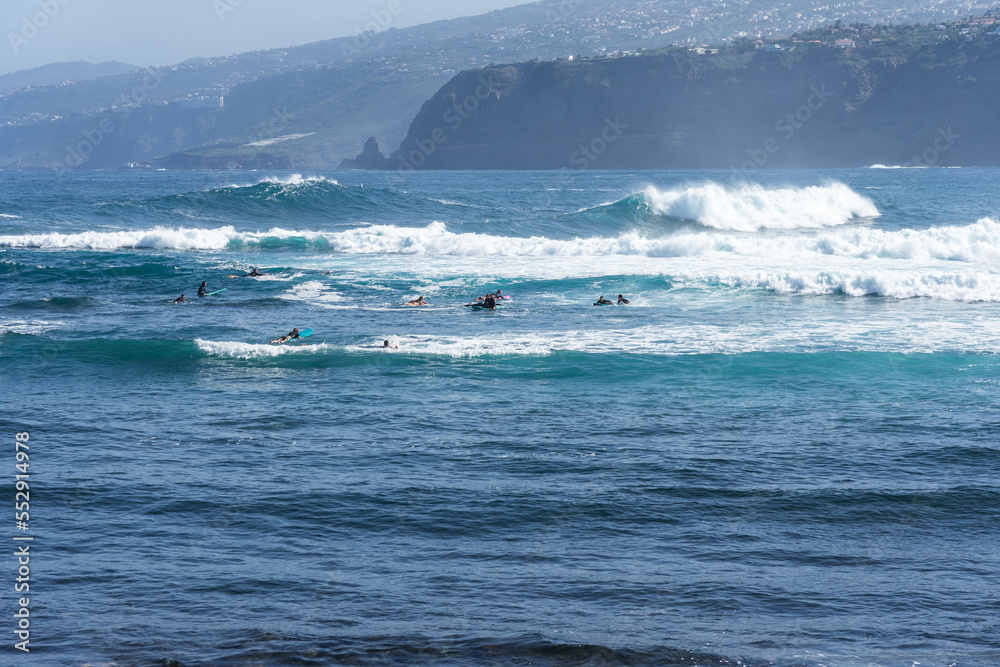A group of surfers on the waves. Tenerife. Canary Islands. Spain