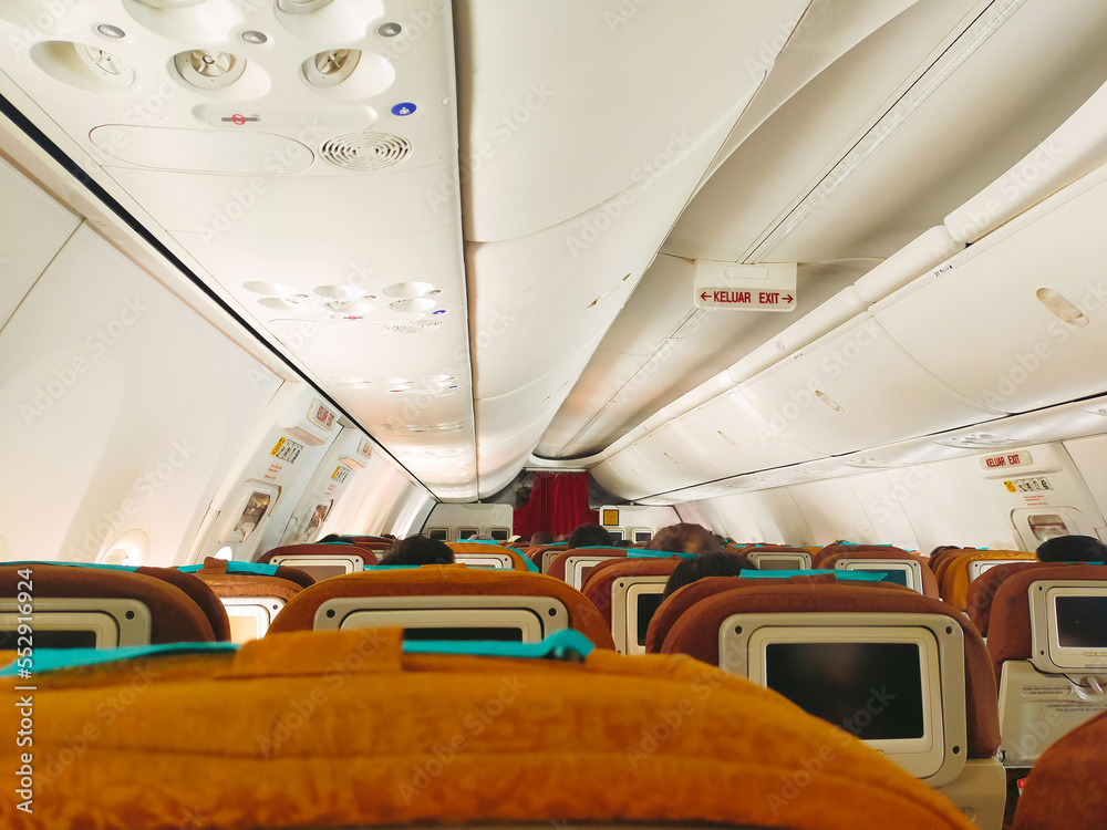 Fototapeta premium View from passenger seat in the commercial airline cabin.