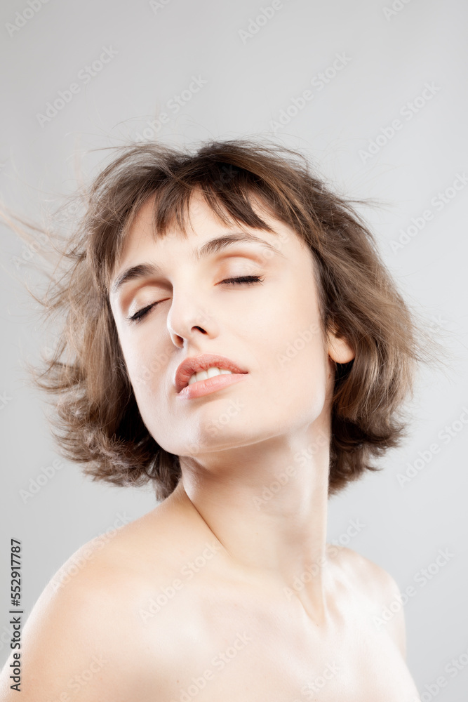 studio portrait of a beautiful brunette girl with short hair in the air studio portrait of a beautiful brunette girl with short hair in the air
