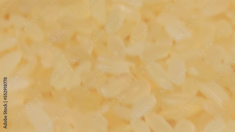 Dry Uncooked Parboiled Rice Rotating - Macro. Scattered Raw Long Grain Rice - Close-Up. Asian Cuisine and Culture. Healthy Eating Ingredients. Diet Food Dry Uncooked Parboiled Rice Rotating - Macro. Scattered Raw Long Grain Rice - Close-Up. Asian Cuisine and Culture. Healthy Eating Ingredients. Diet Food