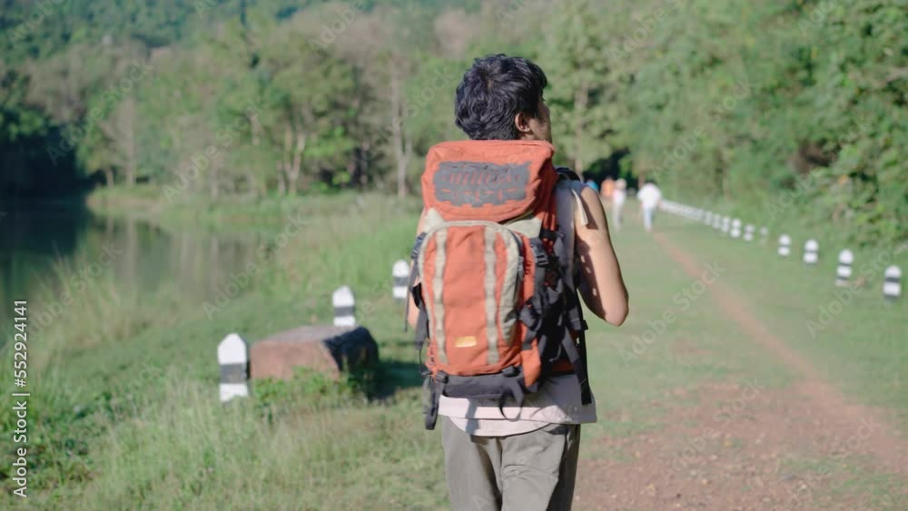 4K Young travel asian man walking on trail up peaceful lush high elevation green forest, Tourist walks on an adventure trip in natural landscape in hike on a environment 4K Young travel asian man walking on trail up peaceful lush high elevation green forest, Tourist walks on an adventure trip in natural landscape in hike on a environment