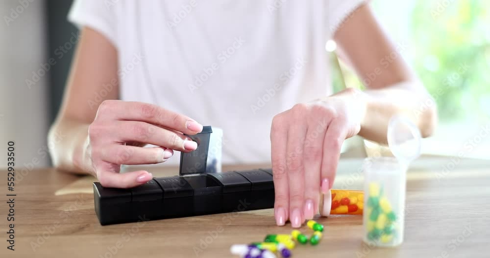Female hands sort pills for every day Female hands sort pills for every day