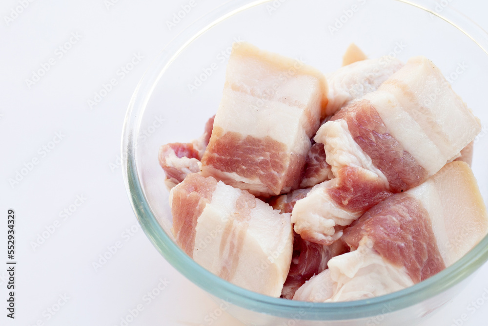 Streaky pork in glass bowl on white background. Streaky pork in glass bowl on white background.