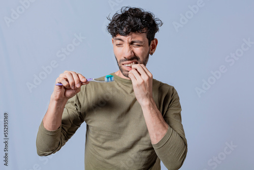 People holding toothbrush with gum pain. Man holding toothbrush with gum pain, People holding toothbrush with gum problem isolated, Person with gingivitis holding toothbrush photo