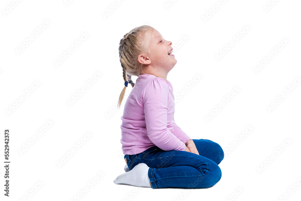 A little girl sits and laughs. Cute blonde child with pigtails in a pink sweater and jeans. Joy, happiness and positivity. Side view. Isolated on white background. A little girl sits and laughs. Cute blonde child with pigtails in a pink sweater and jeans. Joy, happiness and positivity. Side view. Isolated on white background.