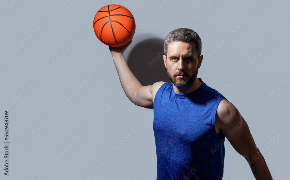 sportsman play dunk basketball isolated on grey background. sportsman play dunk basketball