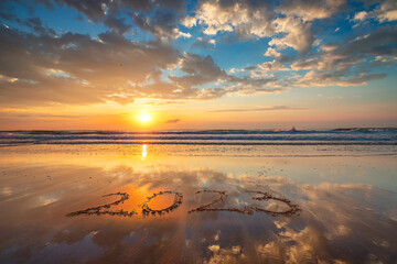 Happy New Year 2023 concept for travel, lifestyle, sport, meditation. 2023 text lettering on the ocean beach sand at sunrise. Sea Sunset of 2022.
