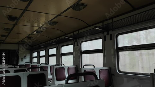 View of the interior of the train during movement. View inside an empty train car. In the cabin of an empty train during the trip. Empty train car.
