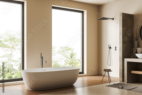Modern light bathroom interior with bathtub and douche, panoramic window © ImageFlow