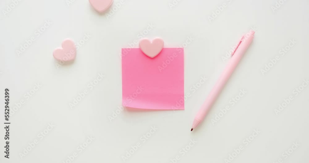 Pink note paper, hearts, pen and paper clips on a white background. Romantic letter with place for text for valentine's day. Looped 4K stop motion animation Pink note paper, hearts, pen and paper clips on a white background. Romantic letter with place for text for valentine's day. Looped 4K stop motion animation