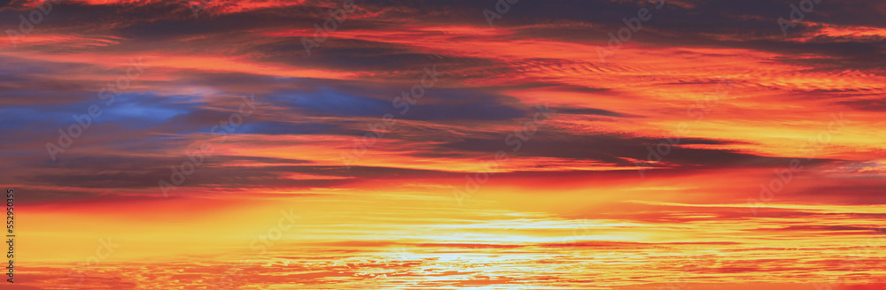 Panoramic View Sky Sunset Sunrise Background. Abstract Saturated Orange-yellow Colors Of Clouds. Unusual Sky Background. Rich Orange Colors. Toned Pink-yellow Clouds. Cloudy Sky. Sunny Cloudscape.