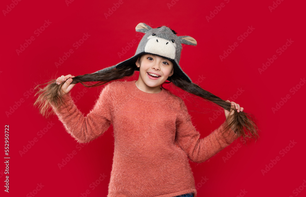 happy teen child wear sweater and earflap hat in studio. winter fashion for teen child. happy teen child wear sweater and earflap hat in studio. winter fashion for teen child.