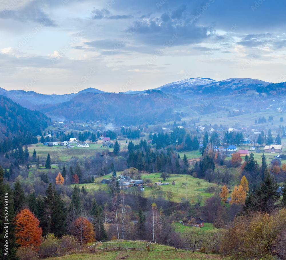 Fototapeta premium Autumn misty mountain landscape (dull day) with village in valley (Carpathian, Ukraine)