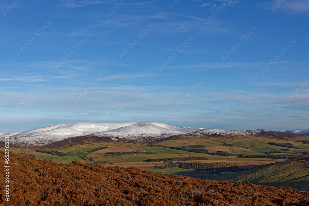 The Snow covered mountains of the Angus Glens from the Heather covered Lower Ramparts of the White Caterthun Iron Age Hill Fort in Scotland. The Snow covered mountains of the Angus Glens from the Heather covered Lower Ramparts of the White Caterthun Iron Age Hill Fort in Scotland.