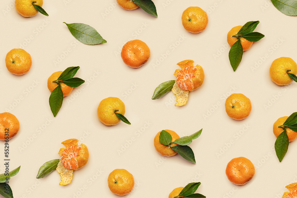 Orange yellow juicy tangerines with green leaves, whole and peeled on neutral beige background, geometric pattern. Citrus fruits mandarins, healthy fruits food concept, creative photo, top view Orange yellow juicy tangerines with green leaves, whole and peeled on neutral beige background, geometric pattern. Citrus fruits mandarins, healthy fruits food concept, creative photo, top view