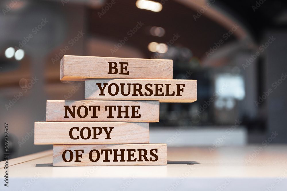 Wooden blocks with words 'Be Yourself Not The Copy Of Others'.