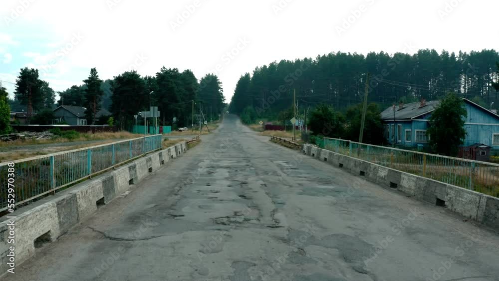 Bad car road. Awful condition of highway with pits, portholes, old damaged asphalt with holes, cracks, portholes from drone copter flying Bad car road. Awful condition of highway with pits, portholes, old damaged asphalt with holes, cracks, portholes from drone copter flying