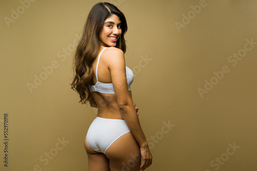 Beautiful hispanic woman looking confident wearing underwear