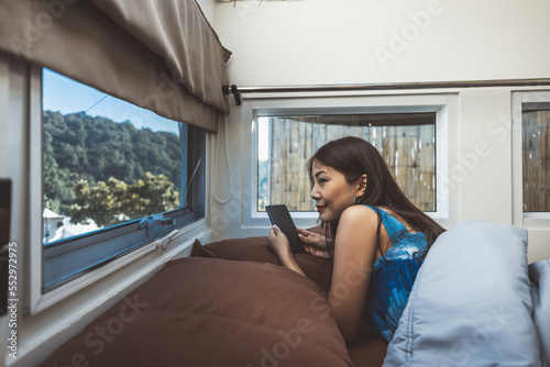 Travel woman with mobile phone relax inside a camper car recreational vehicle