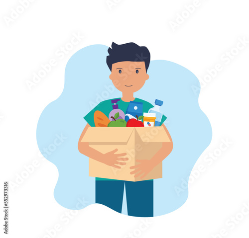 Young man carries a box of food. Social care, volunteering and charity concept.