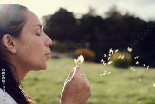 Native american woman blowing dandelion