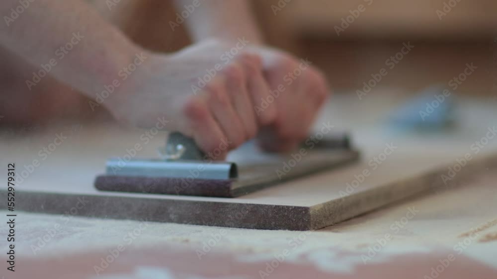 Carpenter grinders sanding wooden board. Close up of hands. Super slow motion Carpenter grinders sanding wooden board. Close up of hands. Super slow motion