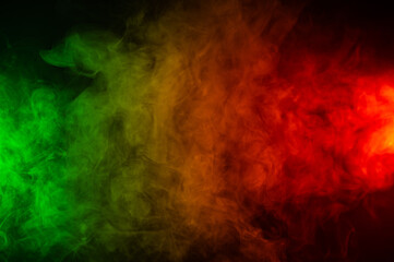 Red yellow green smoke on a black background.