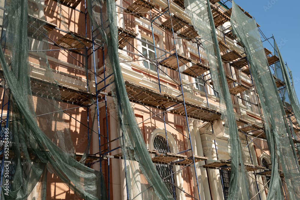 Building structure with netting shade and scaffolding covered Building structure with netting shade and scaffolding covered